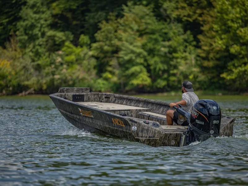 Slide: The Image of Excel Boats Tomahawk 183, 2026, cruising on a river with lush forest backdrop. - 13