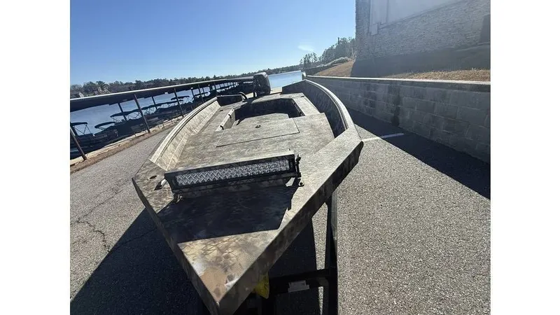 Slide: The Image of 2026 Excel Boats Tomahawk 183 on a trailer by the water. - 3