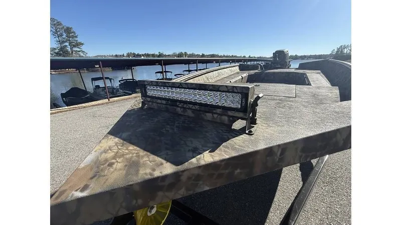 Slide: The Image of 2026 Excel Boats Tomahawk 183 with camouflage pattern by the lake. - 5