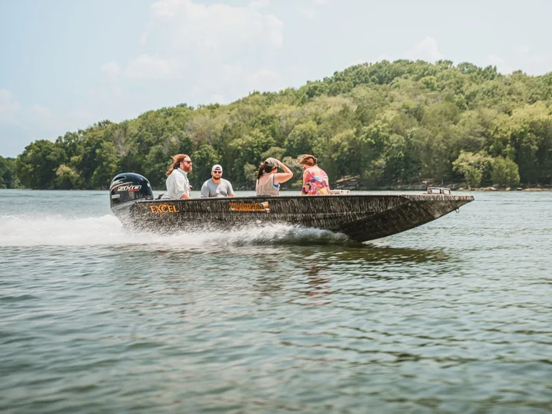 Slide: The Image of 2026 Excel Boats Tomahawk 183 on a lake with passengers. - 9