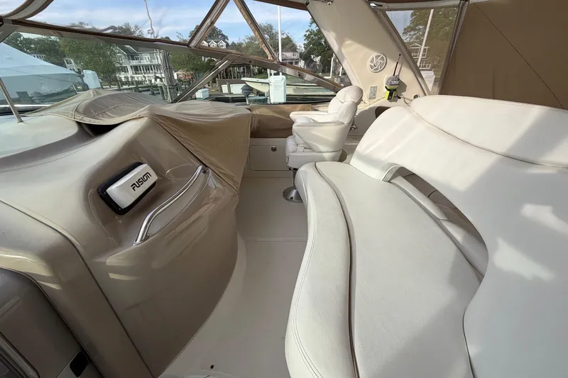 Slide: The Image of Interior of a 2000 Sea Ray Sundancer 460 yacht with white seating and helm. - 12