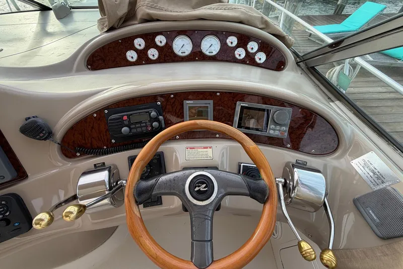 Slide: The Image of Cockpit of 2000 Sea Ray Sundancer 460 with wood steering wheel and control panel. - 13