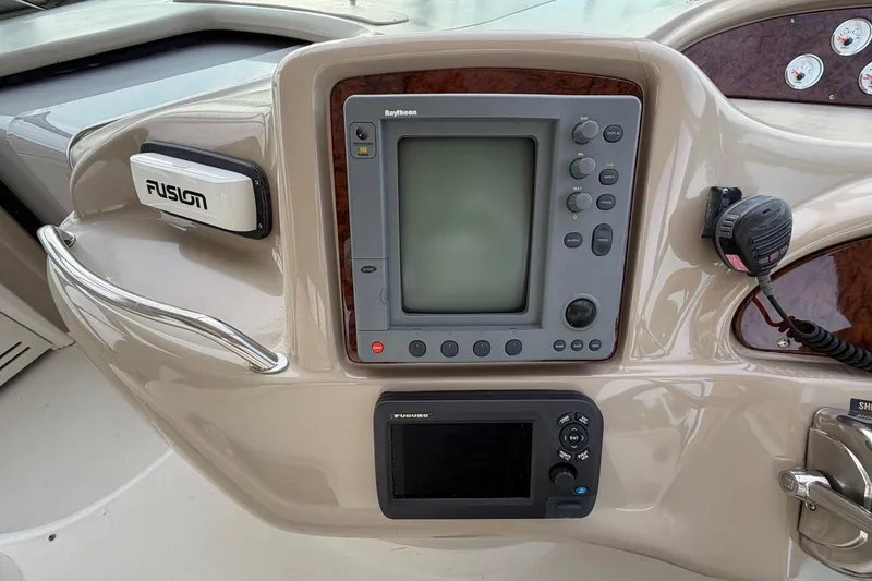 Slide: The Image of Control panel of a 2000 Sea Ray Sundancer 460 with navigation and communication equipment. - 14