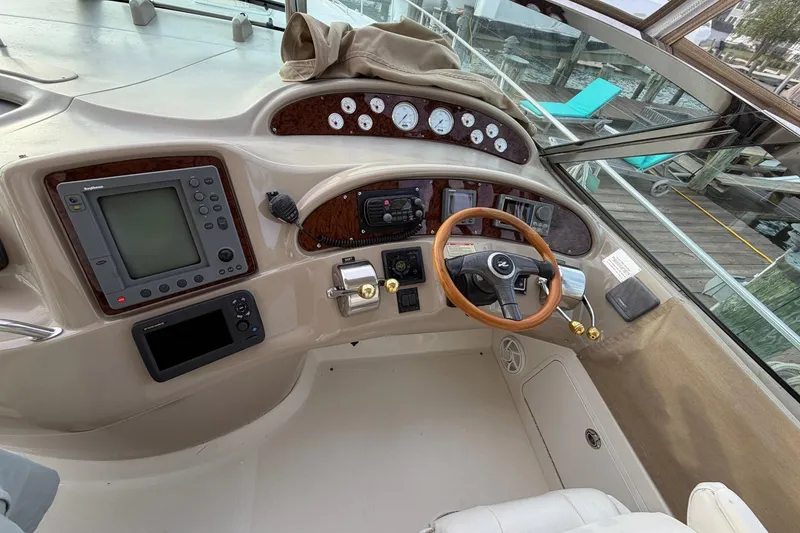 Slide: The Image of Cockpit of 2000 Sea Ray Sundancer 460 yacht with steering wheel and navigation controls. - 15