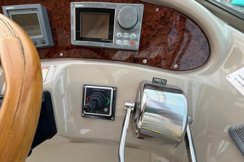 Slide: The Image of Control panel of a 2000 Sea Ray Sundancer 460 yacht with steering wheel and throttle. - 16