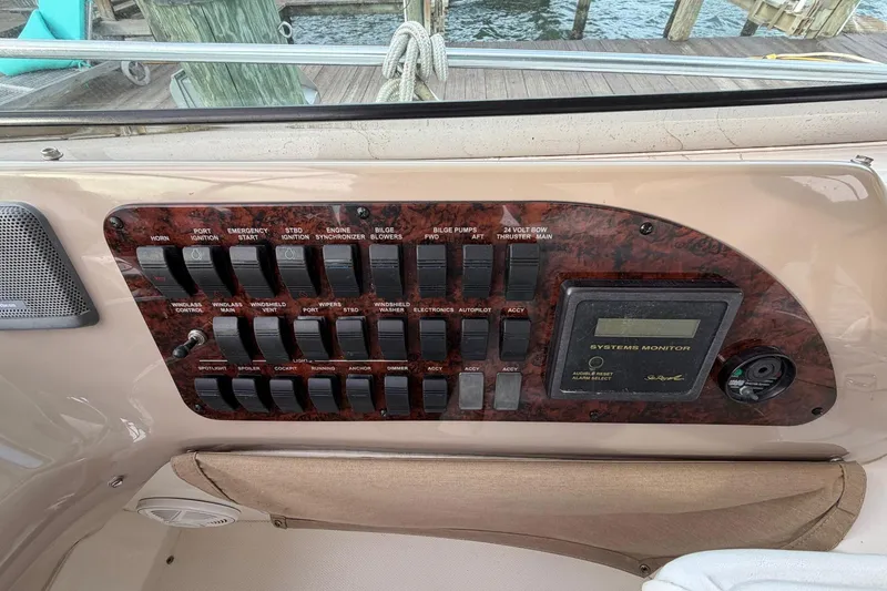 Slide: The Image of Control panel of a 2000 Sea Ray Sundancer 460 boat with various switches and systems monitor. - 17