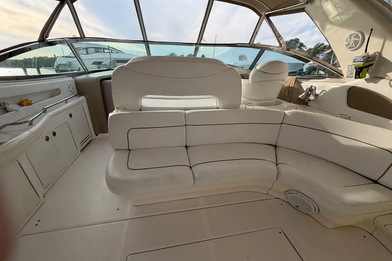 Slide: The Image of Interior of a 2000 Sea Ray Sundancer 460 yacht with white seating and panoramic windows. - 21