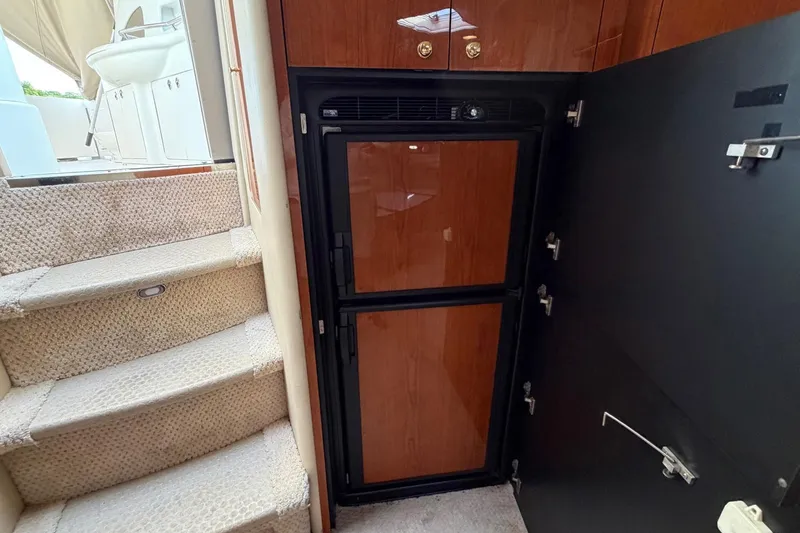 Slide: The Image of Interior of 2000 Sea Ray Sundancer 460 yacht with wooden cabinetry and carpeted stairs. - 27