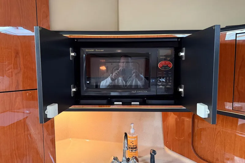 Slide: The Image of Microwave in Sea Ray Sundancer 460 yacht kitchen, 2000 model, with wooden cabinetry. - 28