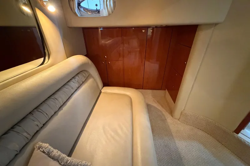 Slide: The Image of Luxurious interior of 2000 Sea Ray Sundancer 460 yacht with plush seating and wooden cabinetry. - 32