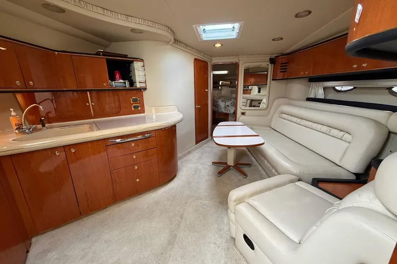 Slide: The Image of Luxurious interior of 2000 Sea Ray Sundancer 460 yacht with kitchen and seating area. - 33