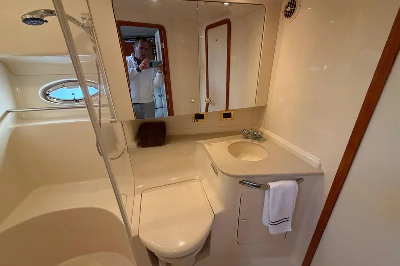 Slide: The Image of Luxurious bathroom in a 2000 Sea Ray Sundancer 460 yacht, featuring modern fixtures and elegant design. - 38
