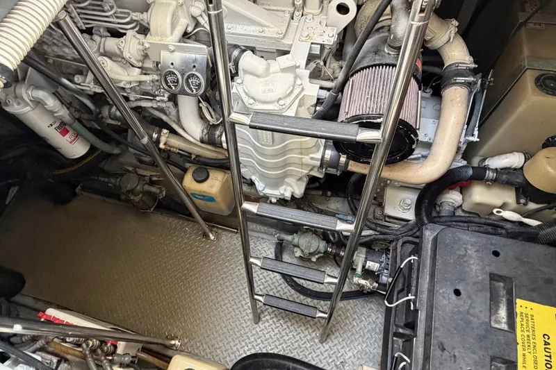 Slide: The Image of Engine compartment of a 2000 Sea Ray Sundancer 460 with visible machinery and ladder. - 41