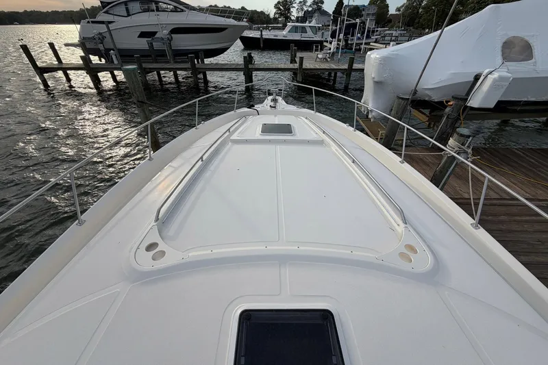 Slide: The Image of Bow view of a 2000 Sea Ray Sundancer 460 docked at a marina. - 5