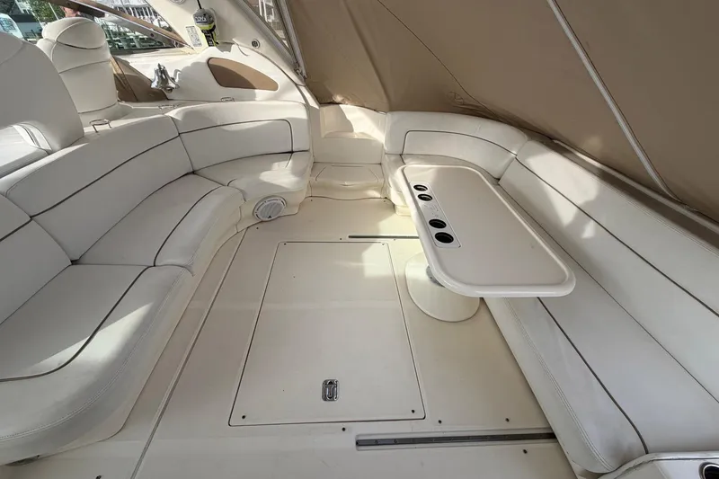 Slide: The Image of Luxurious interior of 2000 Sea Ray Sundancer 460 yacht with white seating and table. - 8