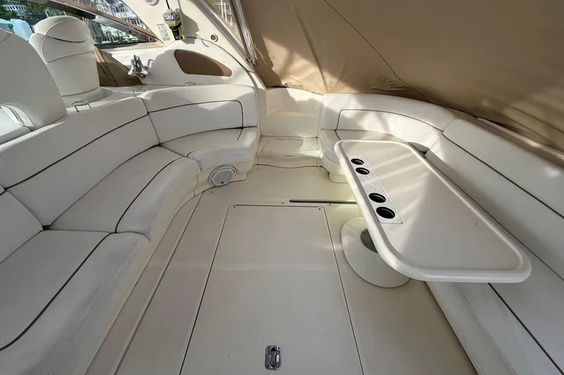 Slide: The Image of Luxurious interior of 2000 Sea Ray Sundancer 460 yacht with white seating and table. - 9