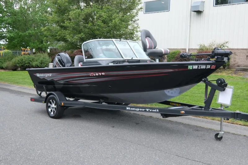 The Image of 2018 Ranger VS1670 WT boat on trailer, parked outdoors near greenery. - 1