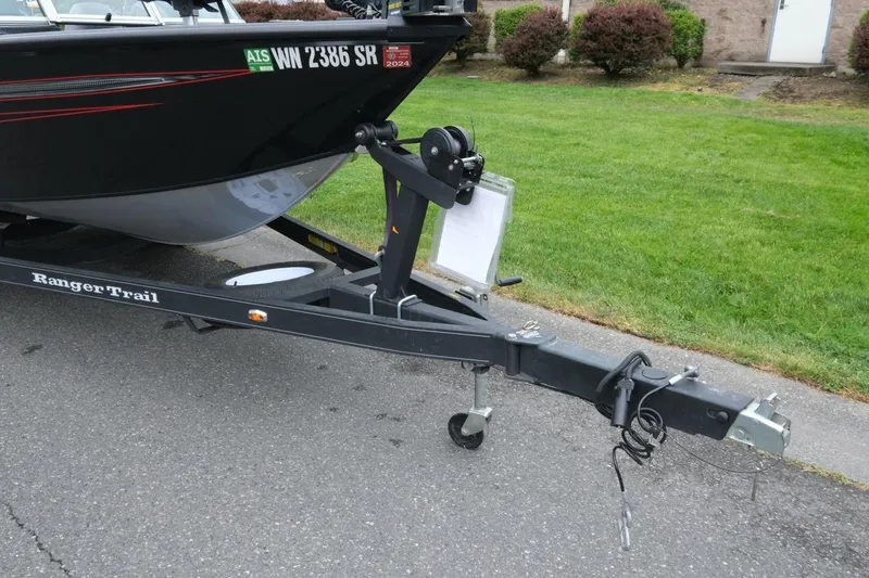 Slide: The Image of 2018 Ranger VS1670 WT boat on Ranger Trail trailer, parked on pavement. - 17
