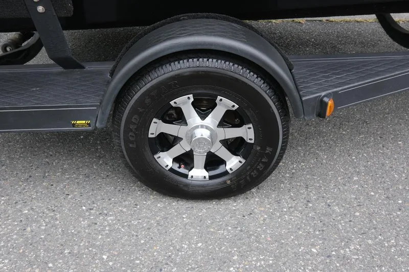 Slide: The Image of 2018 Ranger VS1670 WT trailer wheel on asphalt, featuring Load Star tire. - 18