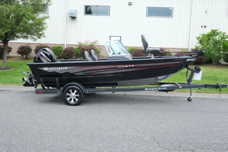Slide: The Image of 2018 Ranger VS1670 WT fishing boat on trailer, parked outdoors. - 2