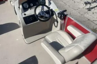 Slide: The Image of 2023 Cypress Cay Seabreeze 232 boat interior with steering wheel and seating. - 10