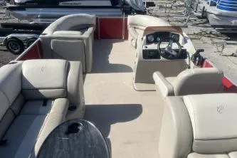 Slide: The Image of 2023 Cypress Cay Seabreeze 232 pontoon boat interior with beige seating and steering console. - 11