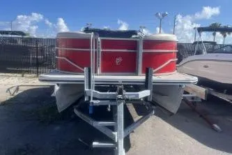 Slide: The Image of 2023 Cypress Cay Seabreeze 232 pontoon boat with red exterior on a trailer. - 3