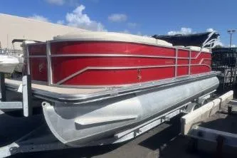 Slide: The Image of 2023 Cypress Cay Seabreeze 232 pontoon boat with red exterior on a trailer. - 4