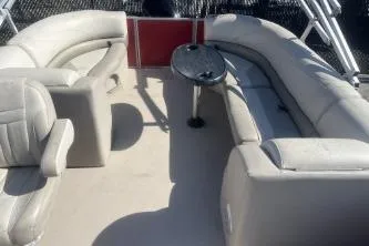 Slide: The Image of 2023 Cypress Cay Seabreeze 232 pontoon boat interior with plush seating and table. - 9