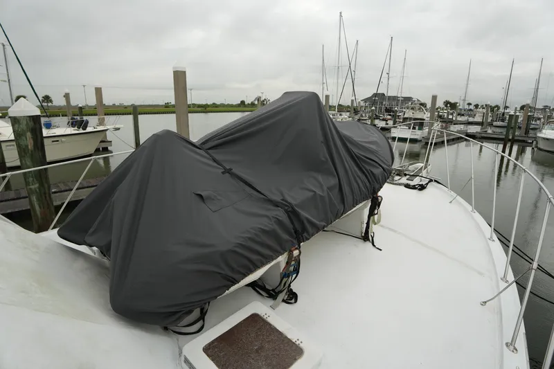 Slide: The Image of Covered equipment on 1980 Hatteras 50 Convertible yacht at marina. - 10