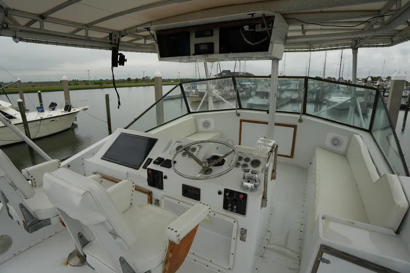 Slide: The Image of 1980 Hatteras 50 Convertible yacht helm with steering wheel and navigation equipment. - 18