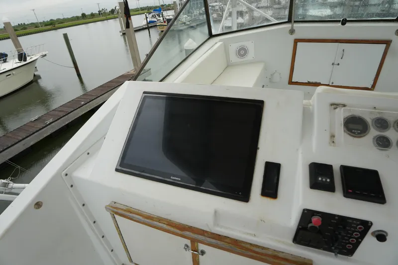 Slide: The Image of Control panel of a 1980 Hatteras 50 Convertible yacht at a marina dock. - 20