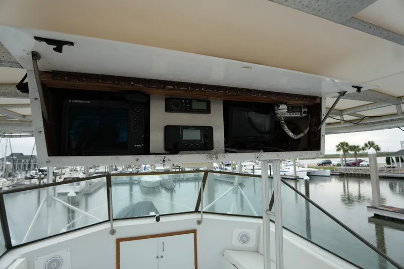Slide: The Image of Control panel of a 1980 Hatteras 50 Convertible yacht overlooking marina. - 21