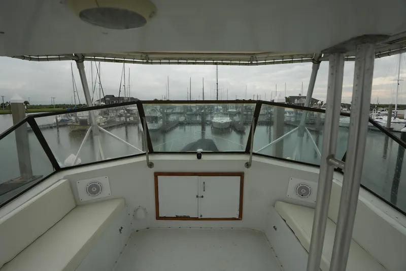 Slide: The Image of Cockpit view of 1980 Hatteras 50 Convertible yacht docked at marina. - 22