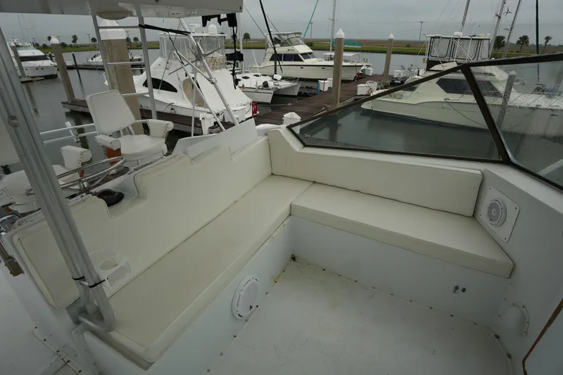 Slide: The Image of 1980 Hatteras 50 Convertible yacht with spacious seating area in marina setting. - 24