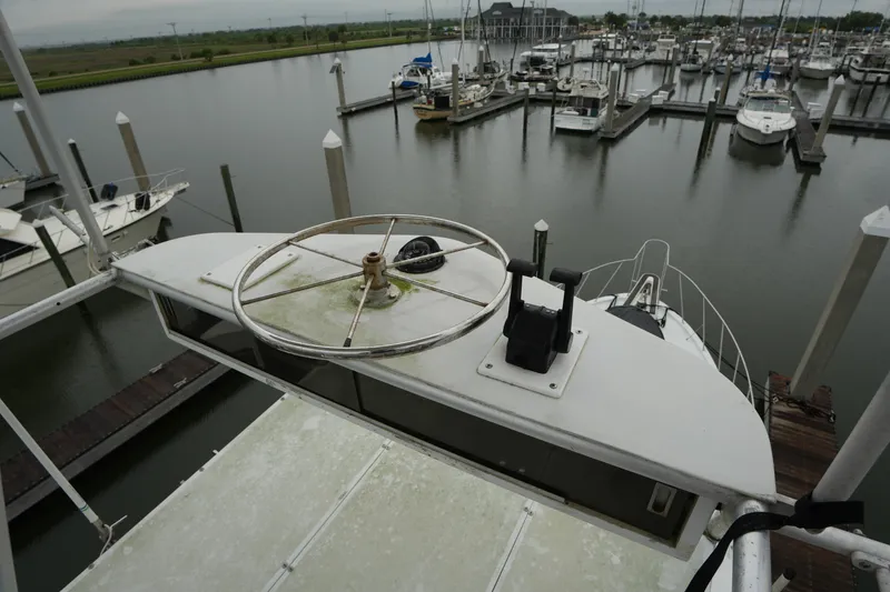 Slide: The Image of 1980 Hatteras 50 Convertible yacht docked in a marina, view from above. - 28