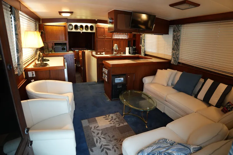 Slide: The Image of Interior of 1980 Hatteras 50 Convertible yacht with cozy seating and elegant decor. - 31