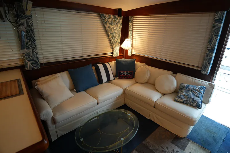 Slide: The Image of Interior of 1980 Hatteras 50 Convertible yacht with cozy seating and nautical decor. - 32