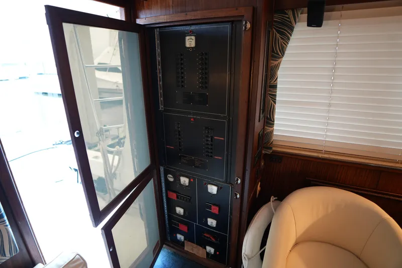 Slide: The Image of Electrical panel inside a 1980 Hatteras 50 Convertible yacht, featuring switches and meters. - 35