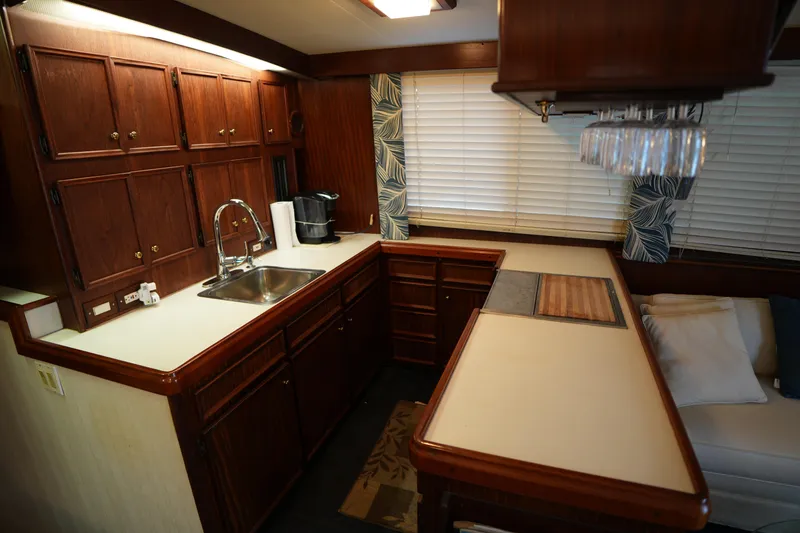 Slide: The Image of 1980 Hatteras 50 Convertible yacht kitchen with wood cabinets and modern amenities. - 36
