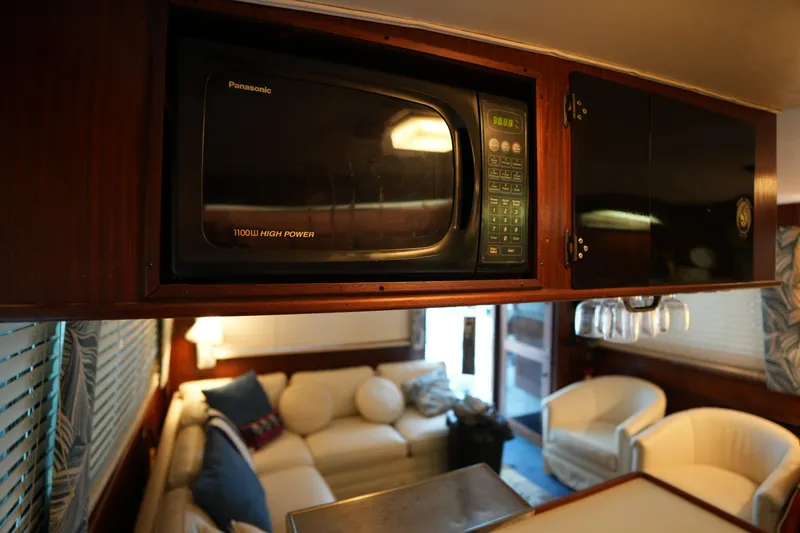 Slide: The Image of Interior of 1980 Hatteras 50 Convertible yacht with microwave and cozy seating area. - 39