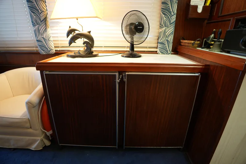 Slide: The Image of Interior of 1980 Hatteras 50 Convertible yacht with lamp and fan on wooden cabinet. - 40