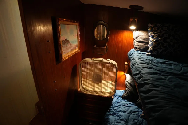 Slide: The Image of Cozy cabin interior of 1980 Hatteras 50 Convertible with fan, painting, and bedding. - 47