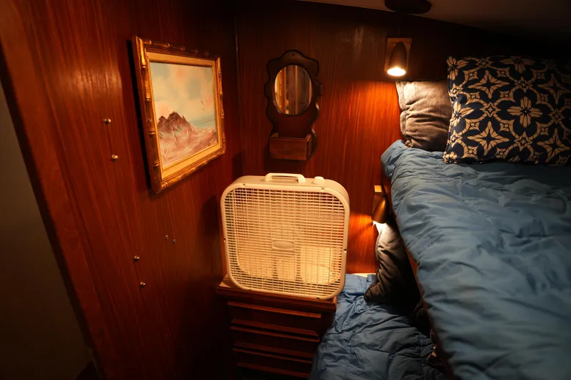 Slide: The Image of Cozy cabin interior of 1980 Hatteras 50 Convertible with fan, painting, and bunk bed. - 49