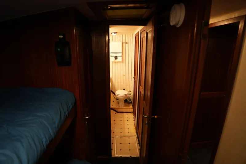 Slide: The Image of Interior of 1980 Hatteras 50 Convertible yacht showing cozy cabin and bathroom. - 50