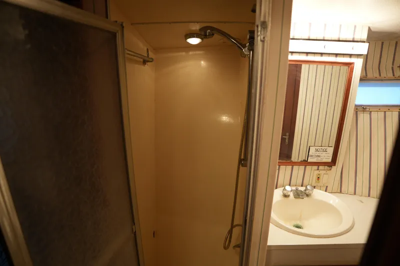 Slide: The Image of Bathroom interior of 1980 Hatteras 50 Convertible yacht with shower and sink. - 52