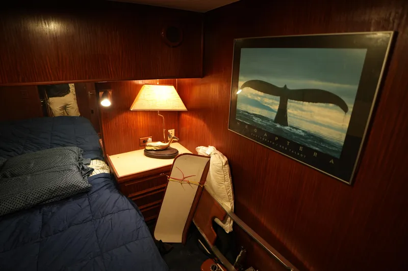Slide: The Image of Cozy cabin interior of 1980 Hatteras 50 Convertible with nautical decor and warm lighting. - 55