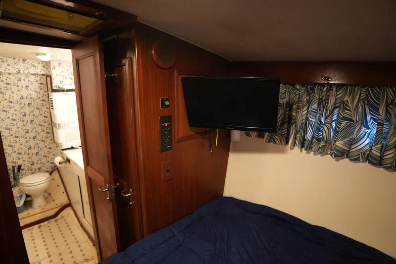 Slide: The Image of Cozy cabin interior of 1980 Hatteras 50 Convertible yacht with TV and bathroom. - 56