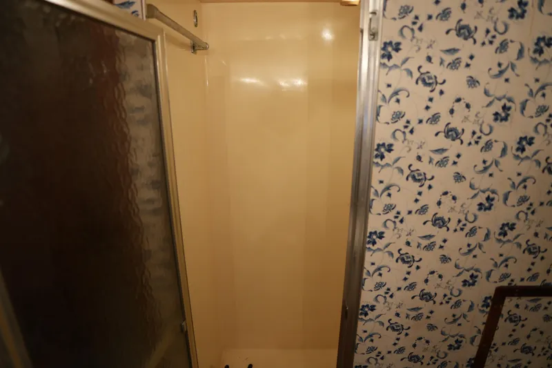 Slide: The Image of Shower area with floral wallpaper in a 1980 Hatteras 50 Convertible yacht. - 58