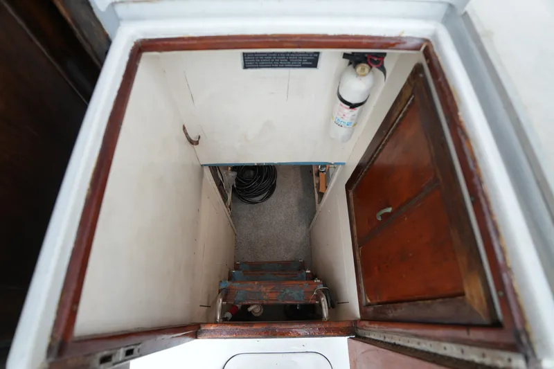 Slide: The Image of Interior view of 1980 Hatteras 50 Convertible boat showing stairs and storage area. - 60